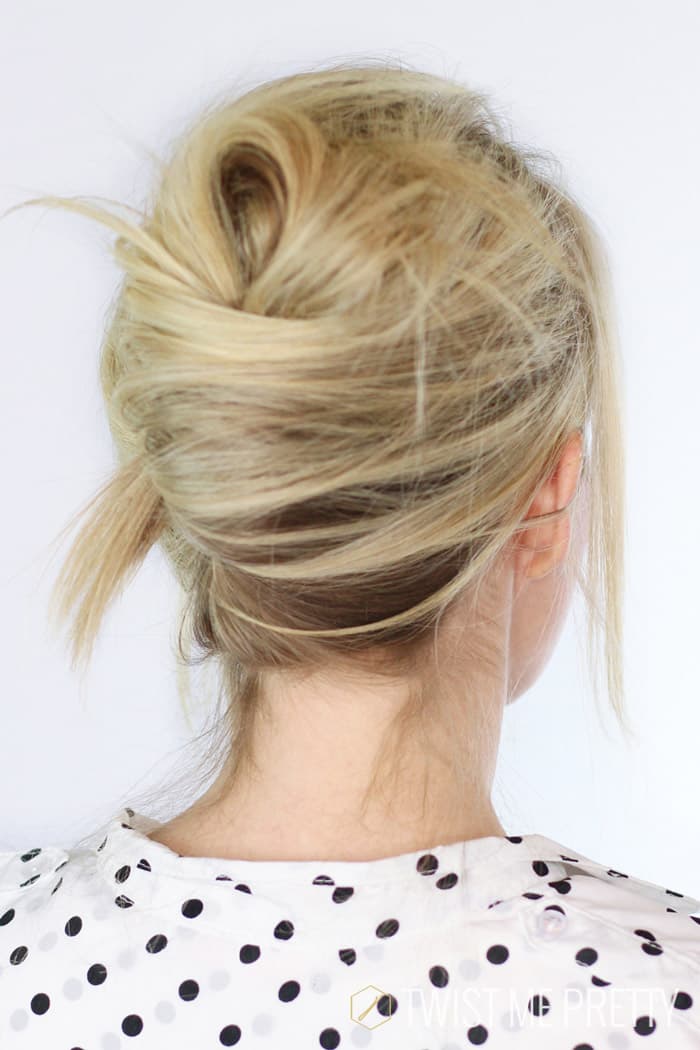 Modern tutorial reference clearly displaying the overlapping cylindrical fold, the hidden vertical seam, and the use of the hair fork.
