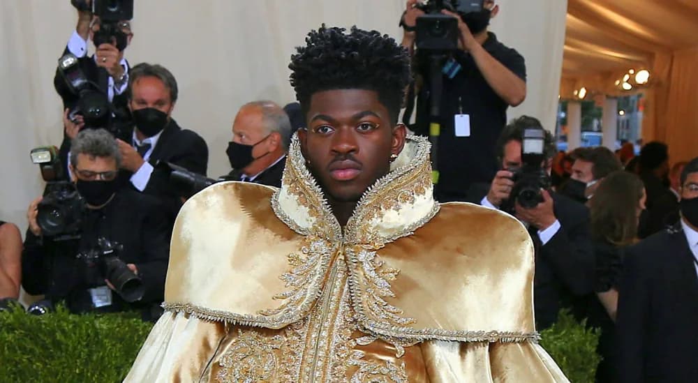 Lil Nas X wearing a gold Atelier Versace cape and armor reveal at the 2021 Met Gala.